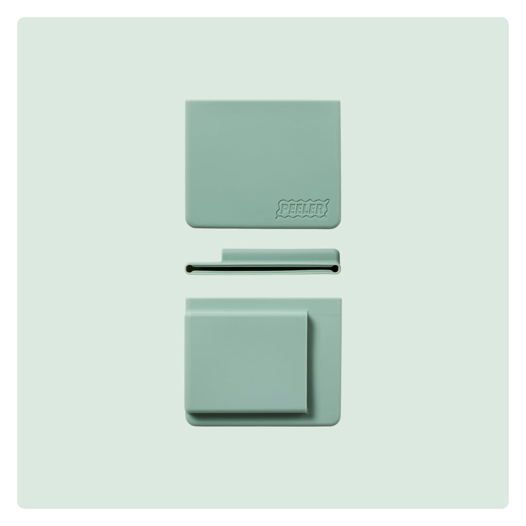 A sage-green silicone slim wallet laid flat, showing the front, side and back with the 'Peeler' logo embossed in the corner.