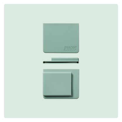 A sage-green silicone slim wallet laid flat, showing the front, side and back with the 'Peeler' logo embossed in the corner.
